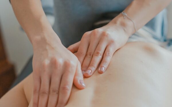 man massaging woman's body